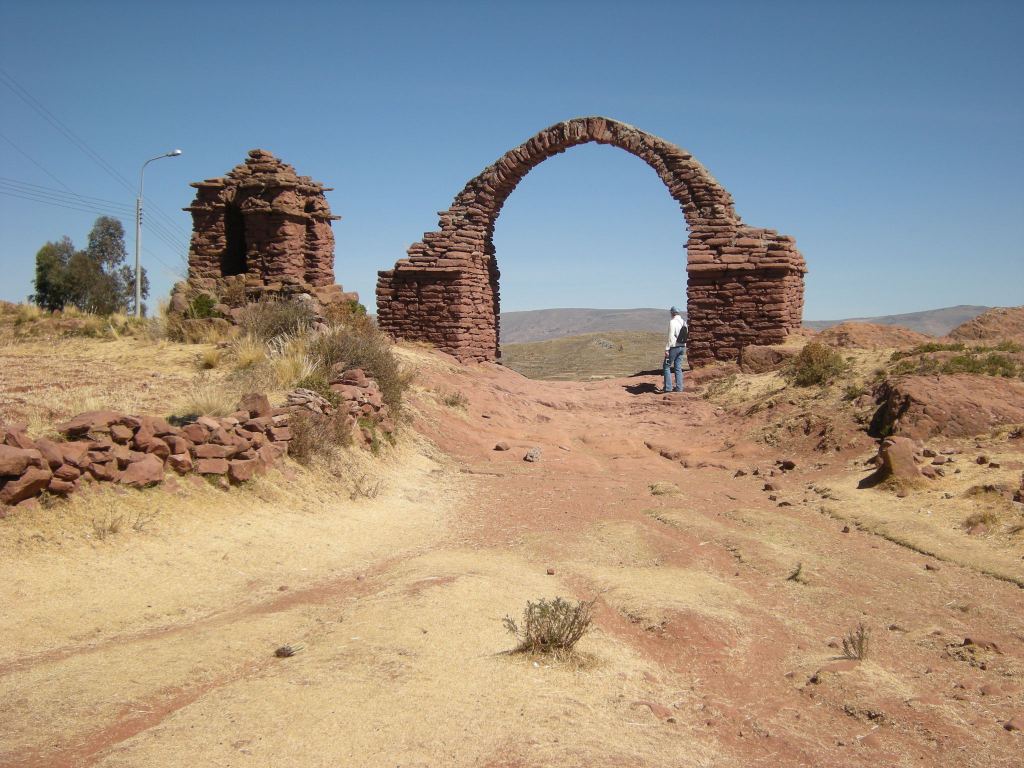 Charley is standing next to the arch, at the top of the path.